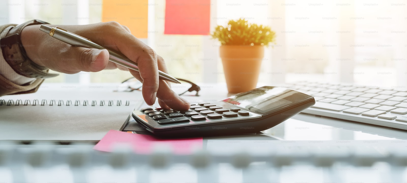 A calculator and financial figures on a desk